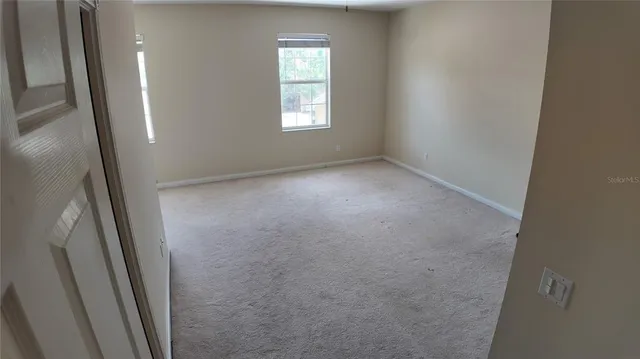 a view of empty room with windows