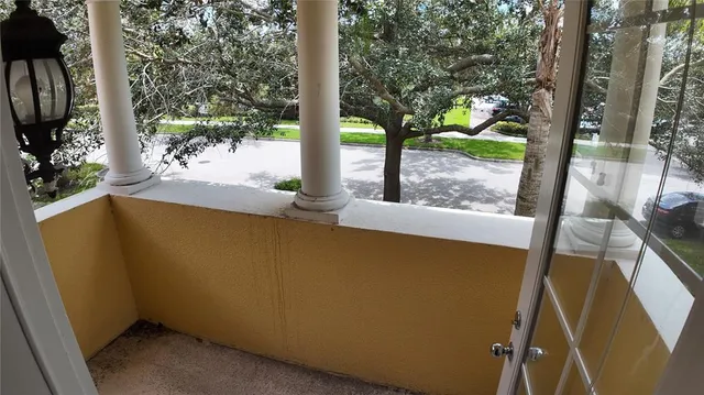 a view of a room that has a bed and glass door