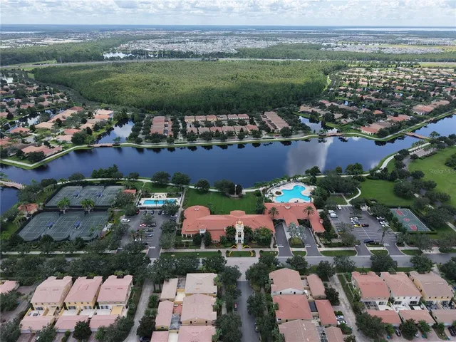 an aerial view of residential houses with outdoor space and street view