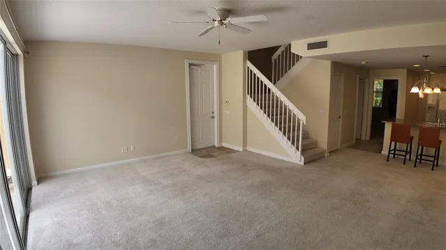 an empty room with windows and stairs