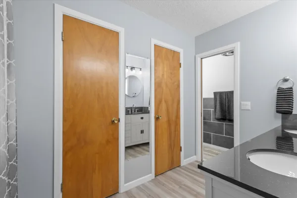 a bathroom with a granite countertop sink and a mirror