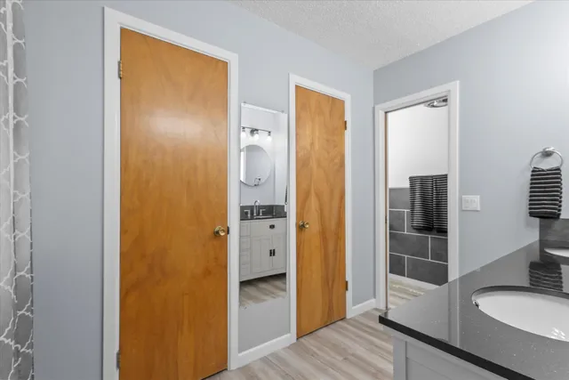 a bathroom with a granite countertop sink and a mirror