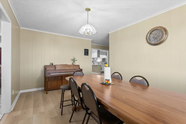 a view of a dining room with furniture and chandelier