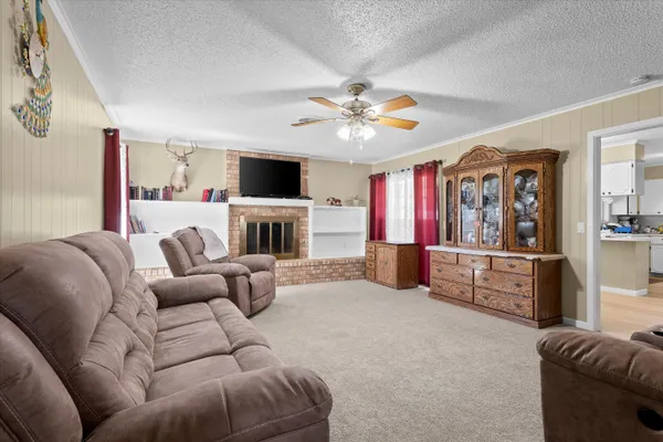 a living room with furniture a fireplace and a flat screen tv