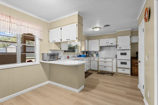 a kitchen with stainless steel appliances a refrigerator and cabinets