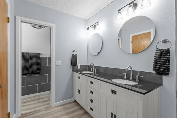 a bathroom with a double vanity sink and a mirror
