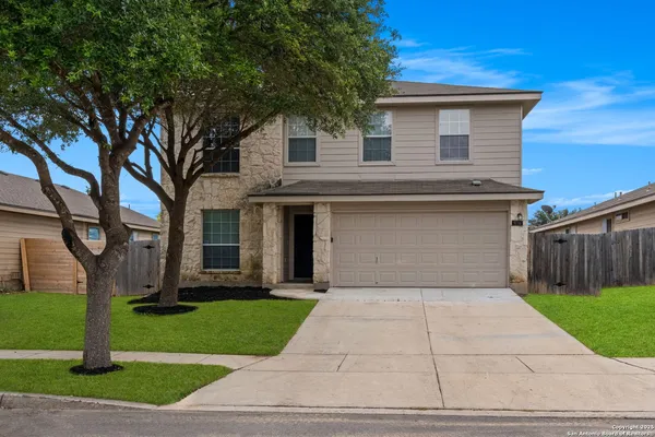 a front view of house with yard and green space