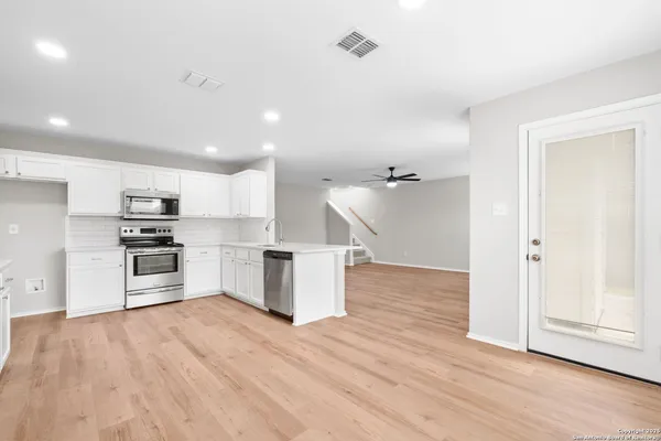 a kitchen with granite countertop a stove and a refrigerator