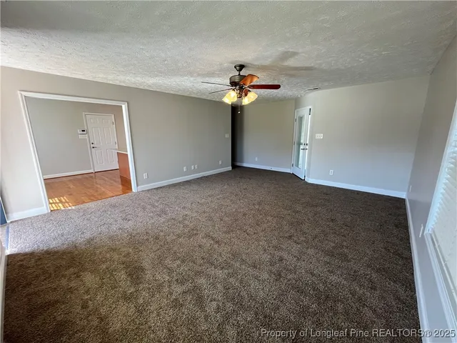 a view of a big room with carpet