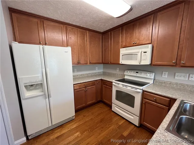 a kitchen with a refrigerator sink and microwave