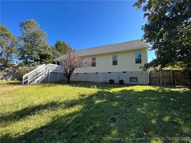 a view of a house with a backyard