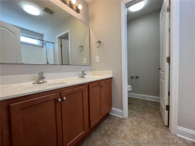 a bathroom with a double vanity sink a and mirror