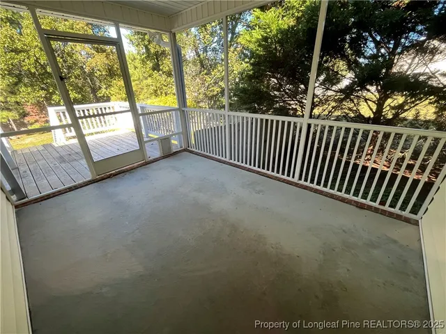 a view of balcony with floor to ceiling window and wooden floor