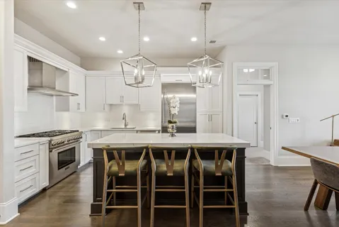 a view of a dining room with furniture a chandelier and wooden floor