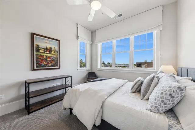 a bedroom with a bed and a large window