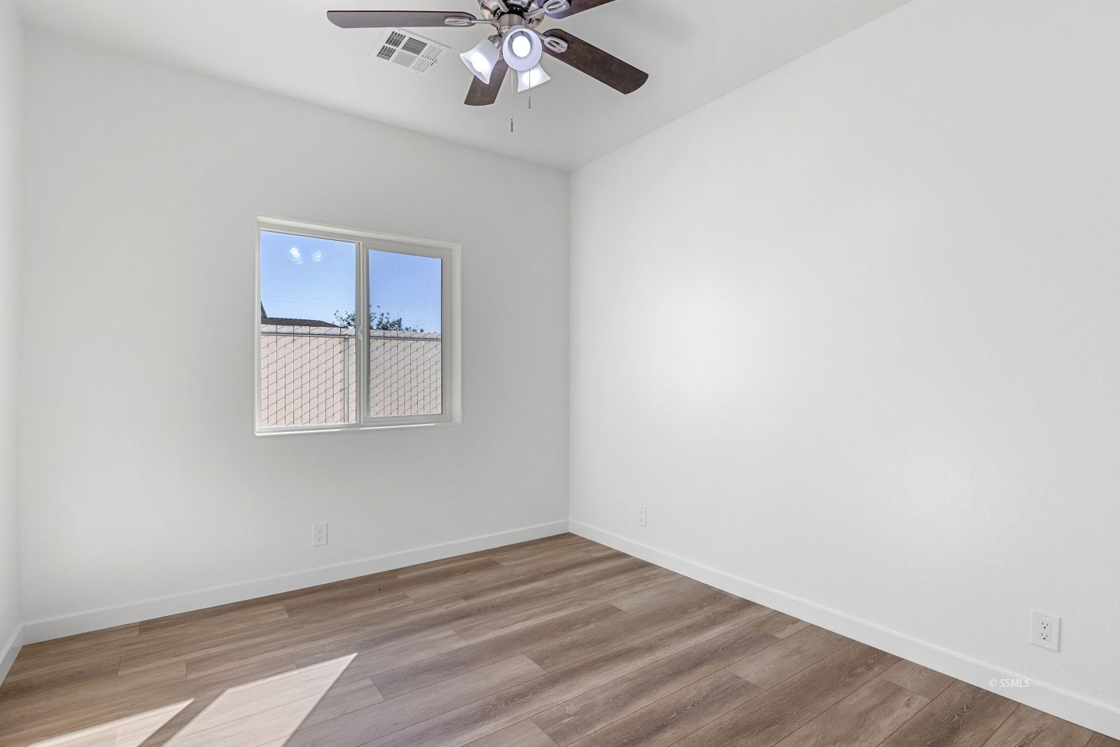 1112 Vulcan Ridgecrest, CA 93555 - Photo 21 of 30 an empty room with a window and wooden floor