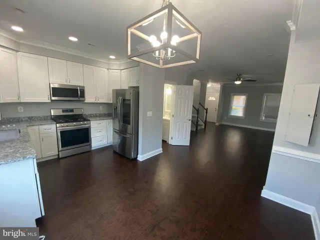 a view of kitchen with cabinets and stainless steel appliances