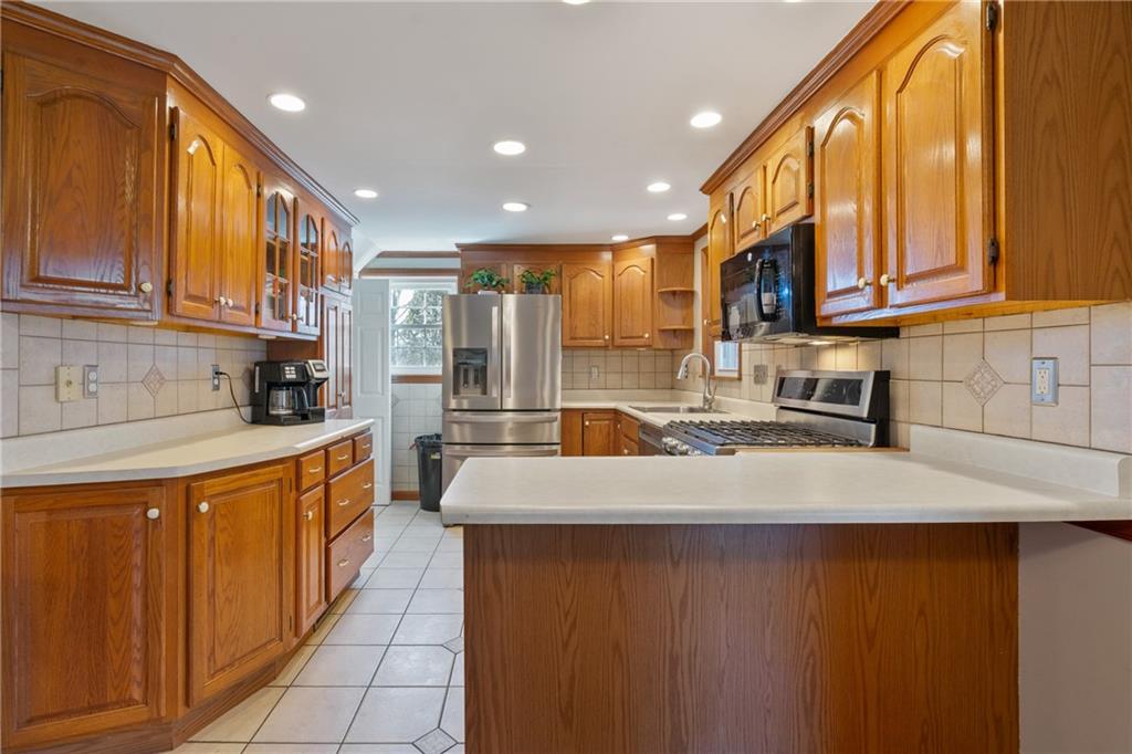 520 Nichols Road Pittsburgh, PA 15237 - Photo 10 of 31 a kitchen with stainless steel appliances granite countertop a sink a stove top oven a counter space and cabinets