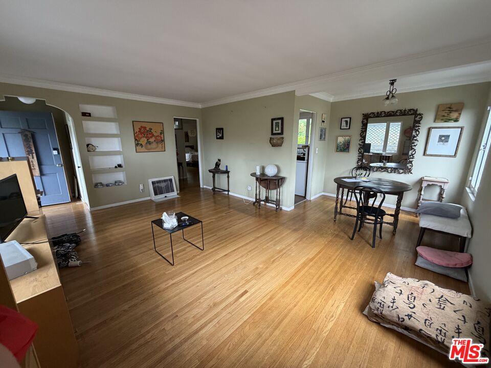 439 Mesa Road Santa Monica, CA 90402 - Photo 3 of 20 a living room with furniture and a dining table with wooden floor