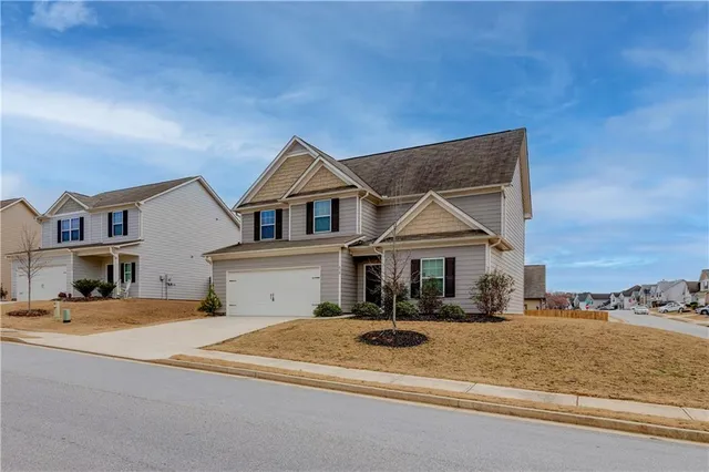 a front view of a house with a yard