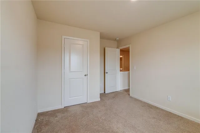 a view of an empty room and closet area