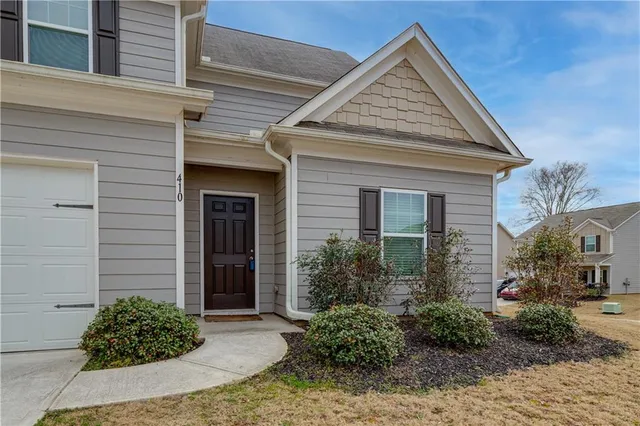 a front view of a house with garden