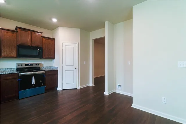 a kitchen with stainless steel appliances granite countertop a stove and a refrigerator
