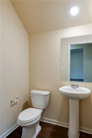 a white toilet sitting next to a bathroom sink