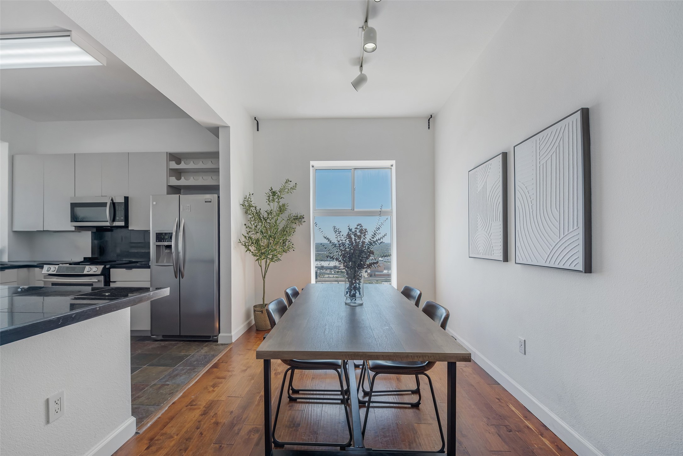 3505 Sage Road, Unit 2210 Houston, TX 77056 - Photo 4 of 40 The dining area sits just off the spacious kitchen, both enhanced by tall windows that flood the space with natural light.