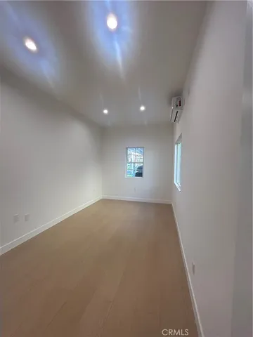 an empty room with a empty space and windows