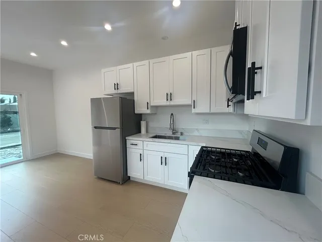 a bathroom with a toilet a sink a mirror and shower