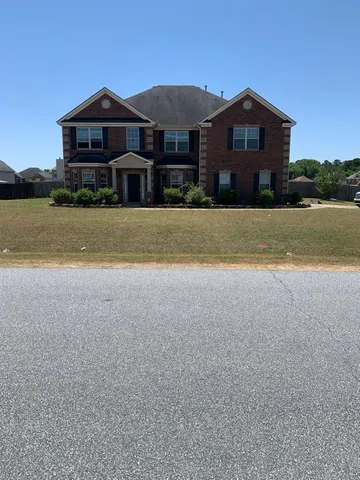a front view of a house with a yard