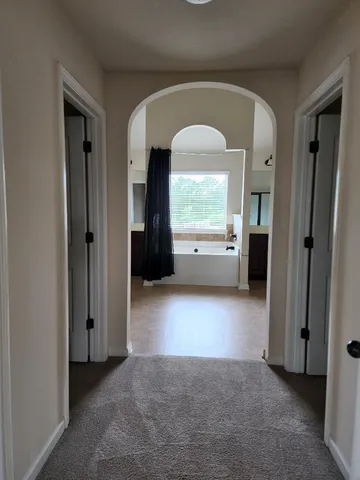 a view of an empty room with a fireplace and a window