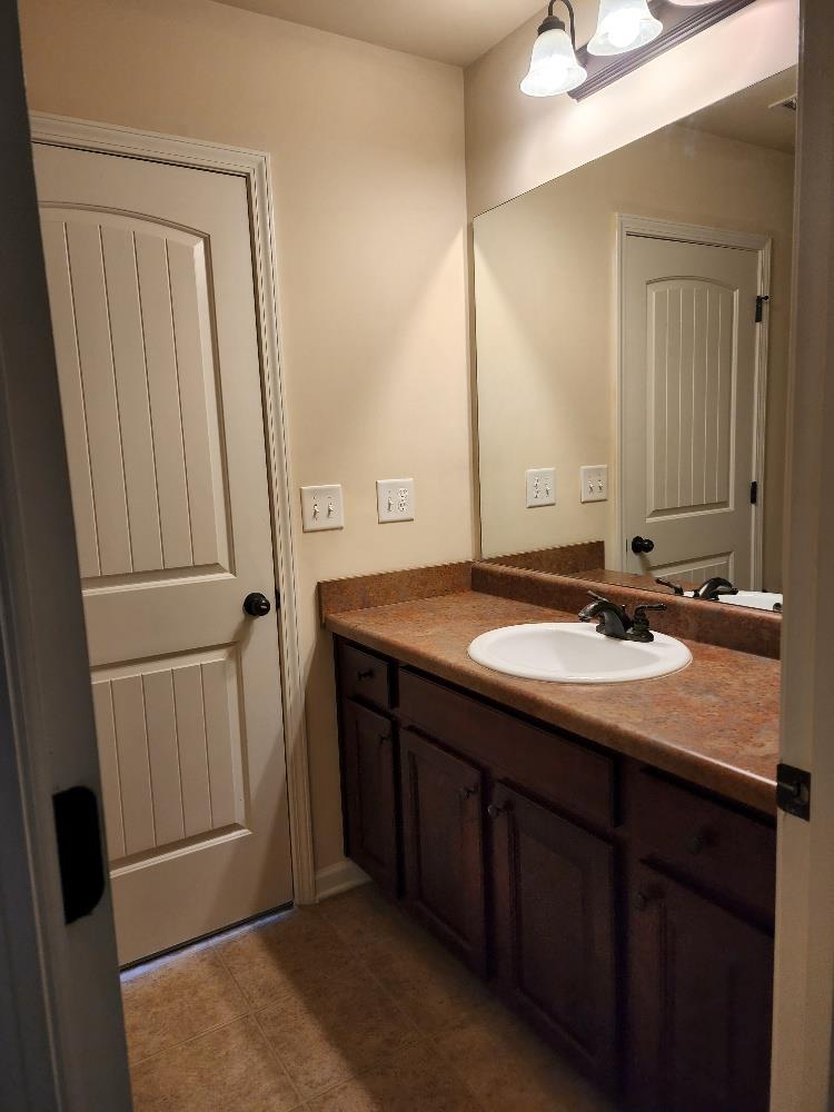 11 Landings Drive Fort Mitchell, AL 36856 - Photo 26 of 31 a bathroom with a sink and a mirror