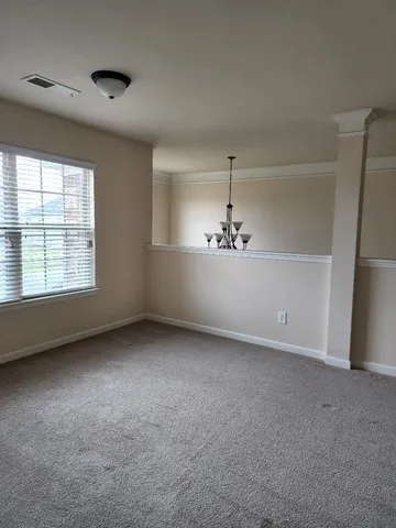 an empty room with a empty space and windows