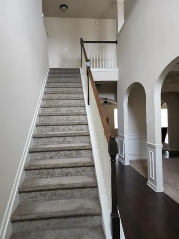 a view of entryway and hall with wooden floor