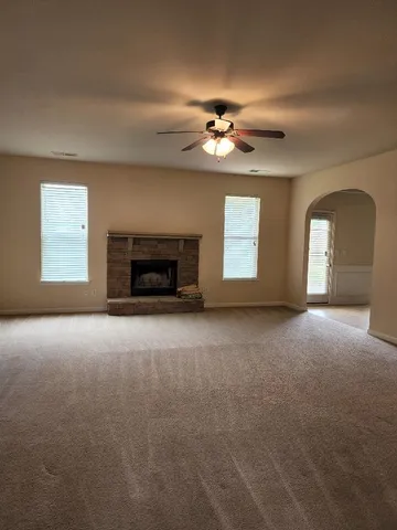 a view of a livingroom with a fireplace and window