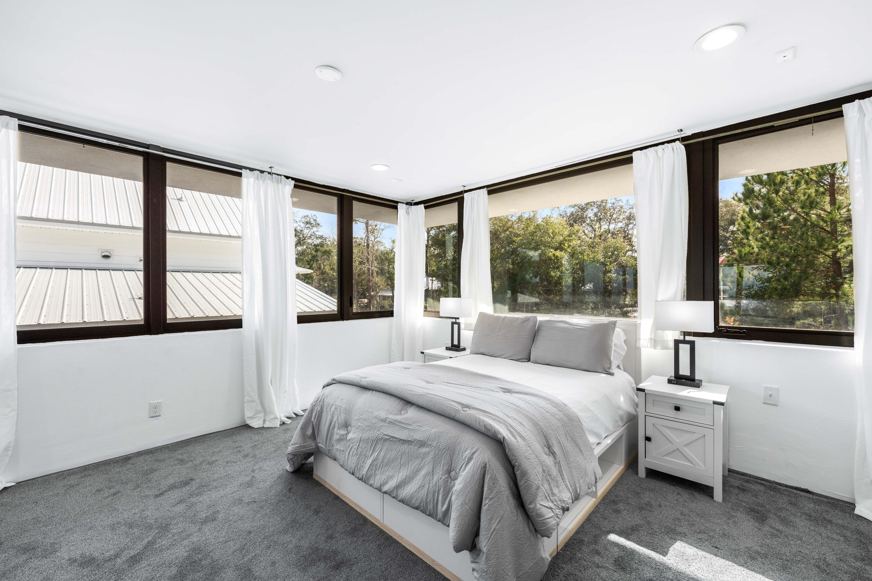 149 Native Tree Lane Santa Rosa Beach, FL 32459 - Photo 25 of 52 a bedroom with a large bed and a large window
