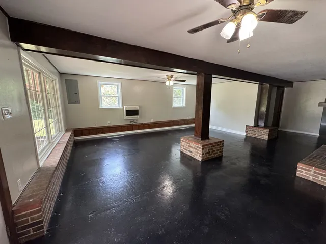 a living room with hard wood floors and a ceiling fan