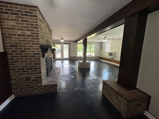 a hallway with wooden floor and furniture