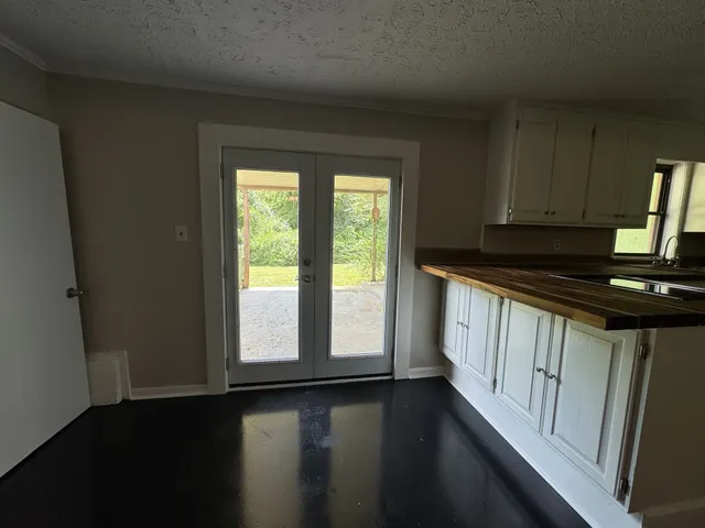 a kitchen with wooden cabinets a stove top oven a sink and a window