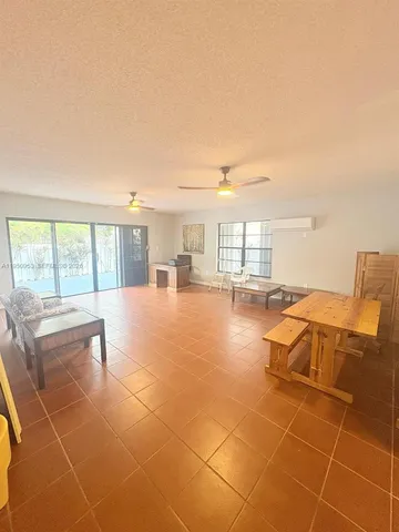 a living room with couches and pool view of living room