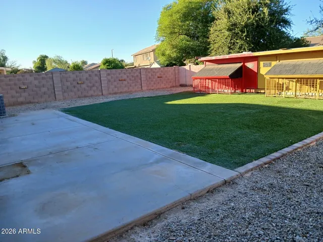 a view of backyard with swimming pool