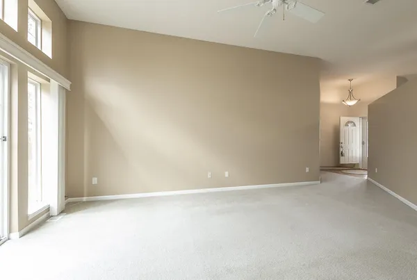 an empty room with a empty space and windows