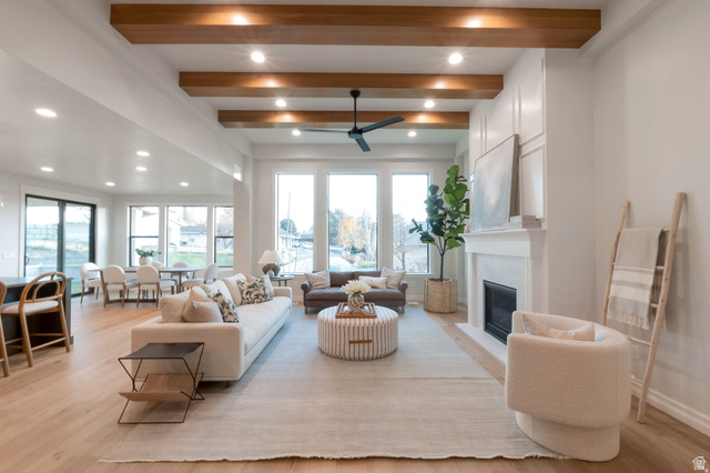 452 Amber Lane, Unit 118 Layton, UT 84041 - Photo 4 of 10 Open concept living space featuring wood-finish flooring, a white-painted fireplace with built-in cabinetry, and a ceiling fan