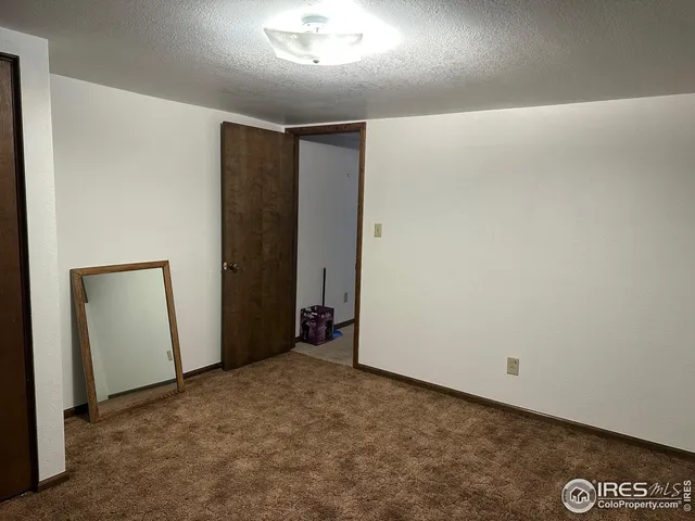 a view of a hallway with wooden cabinets