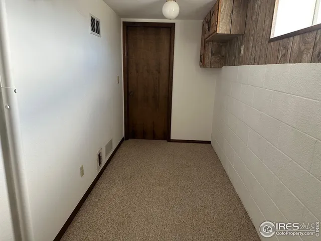 a view of an empty room with empty shelves