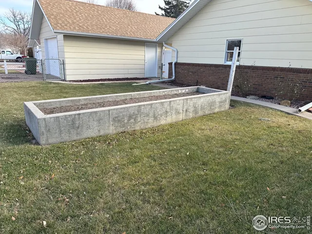 a view of a backyard with table and chairs