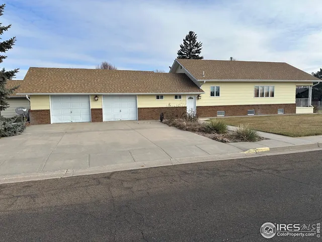 a view of a house with a yard and garage