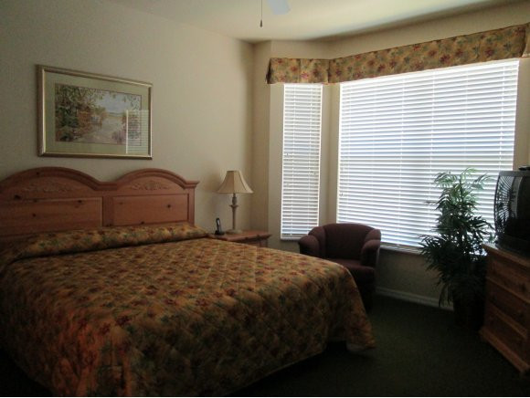7920 Mahogany Run Lane, Unit 1024 Naples, FL 34113 - Photo 11 of 18 a bedroom with a bed and a potted plant